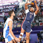 PARIS, FRANCE - AUGUST 02: Kareem Maddox #9 of Team United States shoots over Lucas Dussoulier #0 of Team France during a Men's 3x3 Basketball Pool Round game between the United States and France on day seven of the Olympic Games Paris 2024 at Esplanade Des Invalides on August 02, 2024 in Paris, France. (Photo by Lintao Zhang/Getty Images)