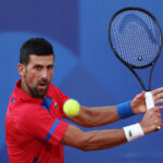 PARIS, FRANCE - AUGUST 02: Novak Djokovic of Serbia plays a backhand during the Tennis Men's Singles Semifinal match against Lorenzo Musetti of Italy on day seven of the Olympic Games Paris 2024 at Roland Garros on August 02, 2024 in Paris, France. (Photo by Clive Brunskill/Getty Images)