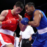 PARIS, FRANCE - AUGUST 02: Turabek Khabibullaev of Team Uzbekistan and Arlen Lopez Cardona of Team Cuba exchange punches during the Men's 80kg Quarterfinal match on day seven of the Olympic Games Paris 2024 at North Paris Arena on August 02, 2024 in Paris, France. (Photo by Richard Pelham/Getty Images)