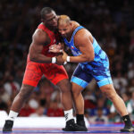 PARIS, FRANCE - AUGUST 06: Mijain Lopez Nunez of Team Cuba (red) competes with Yasmani Acosta Fernandez of Team Chile (blue) during the Wrestling Men's Greco-roman 130kg Gold Medal match on day eleven of the Olympic Games Paris 2024 at Champs-de-Mars Arena on August 06, 2024 in Paris, France. (Photo by Sarah Stier/Getty Images)