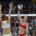 PARIS, FRANCE - AUGUST 06: Sara Hughes of Team United States attacks the net against Tanja Hueberli of Team Switzerland during a Women's Quarterfinal match on day eleven of the Olympic Games Paris 2024 at Eiffel Tower Stadium on August 06, 2024 in Paris, France. (Photo by Elsa/Getty Images)