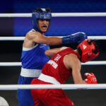 PARIS, FRANCE - AUGUST 06: Imane Khelif of Team Algeria punches Janjaem Suwannapheng of Team Thailand during the Women's 66kg Semifinal round match on day eleven of the Olympic Games Paris 2024 at Roland Garros on August 06, 2024 in Paris, France. (Photo by Matthew Stockman/Getty Images)