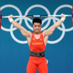 PARIS, FRANCE - AUGUST 07: Fabin Li of Team People's Republic of China performs a snatch during the Weightlifting Men's 61kg on day twelve of the Olympic Games Paris 2024 at South Paris Arena on August 07, 2024 in Paris, France. (Photo by Lars Baron/Getty Images)