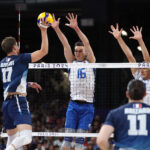 PARIS, FRANCE - AUGUST 07: Trevor Clevenot #17 of Team France attacks the net against Yuri Romano #16 of Team Italy during a Men's Semifinals match on day twelve of the Olympic Games Paris 2024 at Paris Arena on August 07, 2024 in Paris, France. (Photo by Matthew Stockman/Getty Images)