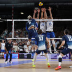 PARIS, FRANCE - AUGUST 07: Earvin Ngapeth #9 of Team France attacks the net against Roberto Russo #19 and Daniele Lavia #15 of Team Italy during a Men's Semifinals match on day twelve of the Olympic Games Paris 2024 at Paris Arena on August 07, 2024 in Paris, France. (Photo by Matthew Stockman/Getty Images)