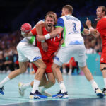 LILLE, FRANCE - AUGUST 07: Petter Oeverby #11 of Team Norway looks to shoot the ball between Borut Mackovsek #51 and Blaz Blagotinsek #3 of Team Slovenia during the Men's Quarterfinal match on day twelve of the Olympic Games Paris 2024 at Stade Pierre Mauroy on August 07, 2024 in Lille, France. (Photo by Alex Davidson/Getty Images)