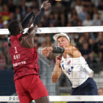 PARIS, FRANCE - AUGUST 07: Miles Partain of Team United States attacks the net against Cherif Younousse of Team Qatar during the Men's Quarterfinal match on day twelve of the Olympic Games Paris 2024 at Eiffel Tower Stadium on August 07, 2024 in Paris, France. (Photo by Julian Finney/Getty Images)