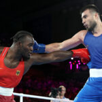 PARIS, FRANCE - AUGUST 07: Nelvie Raman Tiafack of Team Germany and Bakhodir Jalolov of Team Uzbekistan exchange punches during the Men's +92kg Semifinal match on day twelve of the Olympic Games Paris 2024 at Roland Garros on August 07, 2024 in Paris, France.  (Photo by Richard Pelham/Getty Images)