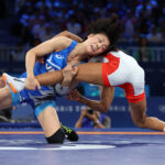 PARIS, FRANCE - AUGUST 08: Akari Fujinami of Team Japan (blue) and Lucia Yamileth Yepez Guzman of Team Ecuador (red) compete in the Wrestling Women's 53kg Gold Medal match on day thirteen of the Olympic Games Paris 2024 at Champs-de-Mars Arena on August 08, 2024 in Paris, France. (Photo by Carl Recine/Getty Images)