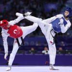 PARIS, FRANCE - AUGUST 08: Yujin Kim of Team Republic of Korea (blue) and Nahid Kiyanichandeh of Team Islamic Republic Iran (red) compete during the Women’s Taekwondo -57kg Gold Medal match on day thirteen of the Olympic Games Paris 2024 at Grand Palais on August 08, 2024 in Paris, France. (Photo by Alex Pantling/Getty Images)