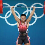 PARIS, FRANCE - AUGUST 08: Weeraphon Wichuma of Team Thailand completes a clean and jerk during the Weightlifting Men's 73kg on day thirteen of the Olympic Games Paris 2024 at South Paris Arena on August 08, 2024 in Paris, France. (Photo by Matthew Stockman/Getty Images)