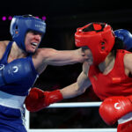 PARIS, FRANCE - AUGUST 08: Caitlin Parker of Team Australia and Qian Li of Team People's Republic of China exchange punches during the Boxing Women's 75kg Semifinal match on day thirteen of the Olympic Games Paris 2024 at Roland Garros on August 08, 2024 in Paris, France. (Photo by Richard Pelham/Getty Images)