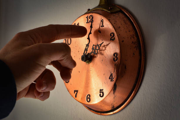 A man changing time on a clock is seen in LAquila, Italy, on March 24, 2023. On march 26th (last ma...