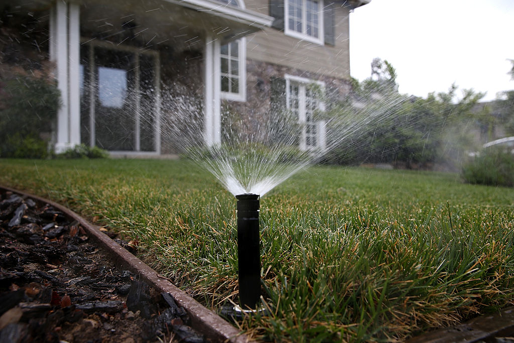 WALNUT CREEK, CA - APRIL 07:  A sprinkler waters a lawn on April 7, 2015 in Walnut Creek, Californi...